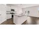 Kitchen island with granite countertops, white cabinets, and hardwood floors at 616 Kimberwick Dr, Locust Grove, GA 30248