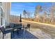 Seating area on the back porch, surrounded by a spacious lawn at 7492 Knoll Hollow Rd, Lithonia, GA 30058