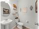 Elegant half-bathroom with pedestal sink and decorative accents at 7492 Knoll Hollow Rd, Lithonia, GA 30058