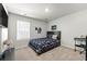 Bedroom with a blue patterned bedspread, a large window, and a TV screen at 7492 Knoll Hollow Rd, Lithonia, GA 30058