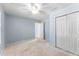 Light blue bedroom with a ceiling fan, double door closet and neutral carpet providing a calm retreat at 889 City Park Se Dr, Atlanta, GA 30312