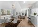 Open-concept dining area with bar seating, bright lighting, and view of the living room at 889 City Park Se Dr, Atlanta, GA 30312