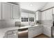 Modern kitchen featuring white cabinets, stainless steel appliances, and a subway tile backsplash at 889 City Park Se Dr, Atlanta, GA 30312