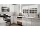 A bright kitchen featuring stainless steel appliances, white cabinets, and a subway tile backsplash at 889 City Park Se Dr, Atlanta, GA 30312