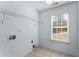 Bright laundry room with tile flooring, a window for natural light, and washer/dryer hookups at 889 City Park Se Dr, Atlanta, GA 30312