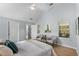 A serene main bedroom featuring a seating area, an ensuite bathroom, and bright hardwood floors at 889 City Park Se Dr, Atlanta, GA 30312