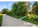 Sidewalk leading to the nearby park, with mature trees and sunny skies at 889 City Park Se Dr, Atlanta, GA 30312