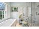 Elegant bathroom featuring a soaking tub, walk-in shower, and stylish fixtures at 11 Ivy Chase Ne, Atlanta, GA 30342