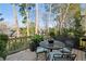 Relaxing deck with table and chairs, offering wooded views at 11 Ivy Chase Ne, Atlanta, GA 30342