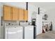 Convenient laundry area with washer, dryer, and overhead cabinets at 11 Ivy Chase Ne, Atlanta, GA 30342