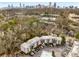 Scenic aerial view of condo complex surrounded by mature trees with the city skyline in the background at 1445 Monroe Ne Dr # B7, Atlanta, GA 30324