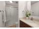 Bathroom featuring a glass-enclosed shower, white tile, a single sink, and a dark vanity at 1445 Monroe Ne Dr # B7, Atlanta, GA 30324