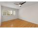 Bedroom with hardwood floors, white walls, large window with shutters, and a ceiling fan at 1445 Monroe Ne Dr # B7, Atlanta, GA 30324