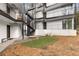 Exterior of a multi-story apartment complex featuring an iron staircase and a green space at 1445 Monroe Ne Dr # B7, Atlanta, GA 30324