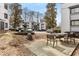 The outdoor courtyard with black wrought iron furniture, stone landscaping, fountain, and parking at 1445 Monroe Ne Dr # B7, Atlanta, GA 30324