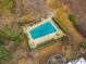 Aerial view of a community pool with many lounge chairs and tables in a fenced enclosure at 1445 Monroe Ne Dr # B7, Atlanta, GA 30324