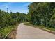 Concrete walking path winding through lush, green Ansley Park neighborhood with mature trees and landscaping at 1445 Monroe Ne Dr # B7, Atlanta, GA 30324