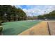 Green basketball court with crisp white lines, offering a great space for recreational games and exercise at 4038 Ash Tree St, Snellville, GA 30039