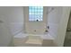 Clean bathroom, featuring a built-in bathtub and window at 4038 Ash Tree St, Snellville, GA 30039