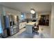 Modern kitchen with stainless steel appliances, granite island, and white cabinets at 4038 Ash Tree St, Snellville, GA 30039