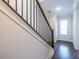 Modern dark-stained wood staircase with black metal railing at 927 Katie Kerr Dr, Decatur, GA 30030