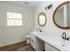 Updated bathroom with double vanity, new flooring and modern fixtures at 3245 Sharon Dr, Powder Springs, GA 30127