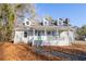 Inviting home exterior with covered porch and landscaping at 3245 Sharon Dr, Powder Springs, GA 30127