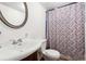 Well-maintained bathroom with a classic vanity, toilet, and shower curtain, offering essential amenities at 5381 Groovers Landing Se Rd, Acworth, GA 30101