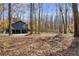 Home's backyard with wooded area and two-car garage at 281 Deer Trace Dr, Mcdonough, GA 30253