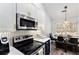 Modern kitchen with stainless steel appliances and hexagon backsplash at 4749 Brookwood Vw, Atlanta, GA 30349