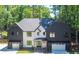 Two-story home featuring a symmetrical facade, two-car garages, and a professionally landscaped front yard at 500 Ridgewater Dr, Marietta, GA 30068