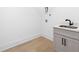 Bright laundry room with a utility sink and light wood floors at 500 Ridgewater Dr, Marietta, GA 30068