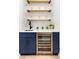 Stylish wet bar with blue cabinetry, quartz countertops, and wine cooler at 500 Ridgewater Dr, Marietta, GA 30068