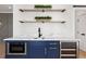 Stylish wet bar with blue cabinets and quartz countertop at 500 Ridgewater Dr, Marietta, GA 30068