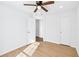 Bright bedroom featuring wood floors, ceiling fan and white doors at 6800 Bells Landing Way, Rex, GA 30273