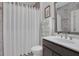 A well-lit bathroom featuring a modern sink, toilet, and a shower behind a white curtain at 885 Stone Crest Rd, Atlanta, GA 30324