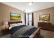 Staged bedroom with warm colors, matching furnishings, and artwork at 40 Brompton Dr, Dallas, GA 30157