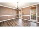 Charming dining room featuring hardwood floors, natural light, and access to an outdoor patio at 40 Brompton Dr, Dallas, GA 30157