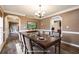 Formal dining room with hardwood floors, chandelier, and adjacent living spaces at 40 Brompton Dr, Dallas, GA 30157