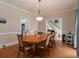 Formal dining room with hardwood floors and an oval wood table at 1049 Laurel Valley Sw Dr, Marietta, GA 30064