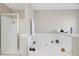 Bathroom featuring a glass-enclosed shower, large soaking tub, and neutral decor at 2116 Tidal Cv, Lawrenceville, GA 30043