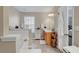 This bright bathroom has a double vanity, a soaking tub, a window and tile floors at 2116 Tidal Cv, Lawrenceville, GA 30043