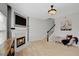 Living room features a decorative fireplace, stairs, and a stylish light fixture at 2116 Tidal Cv, Lawrenceville, GA 30043