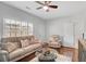Cozy living room features a ceiling fan, hardwood floors and comfortable seating at 2116 Tidal Cv, Lawrenceville, GA 30043