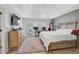 Spacious main bedroom features wood floors, tray ceiling, ceiling fan and a large bed with white comforter at 2116 Tidal Cv, Lawrenceville, GA 30043