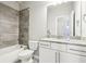 Modern bathroom with granite countertop, white cabinets, and a shower/tub combo at 2445 Santa Rosa St, Alpharetta, GA 30009