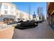 Brick-paved community walkway with shops and parked cars at 2445 Santa Rosa St, Alpharetta, GA 30009