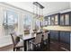 Elegant dining room with a large table, built-in cabinetry, and hardwood floors at 2445 Santa Rosa St, Alpharetta, GA 30009