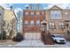 Brick front exterior of a two-story townhome with a two-car garage and stairs leading to the front entrance at 2445 Santa Rosa St, Alpharetta, GA 30009