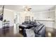 Spacious living room with dark hardwood floors, leather sectional sofa, and a modern fireplace at 2445 Santa Rosa St, Alpharetta, GA 30009